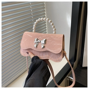 Detail of pink marble pattern PU leather bag with pearl handle and bow clasp