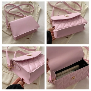 Detail of pink quilted handbag showing golden butterfly buckle and internal storage capacity