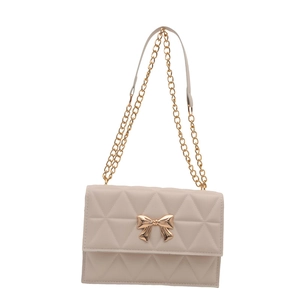 Fashionable beige quilted crossbody bag with golden bow clasp and elegant chain strap