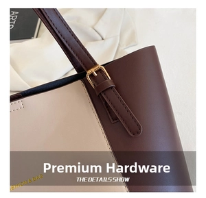 Detail of high-quality gold metal buckle and stitching on a two-tone PU leather tote bag