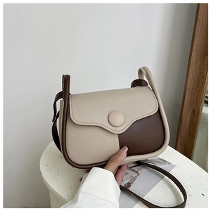 Detail of vintage patchwork crossbody bag with large round button and contrast colors