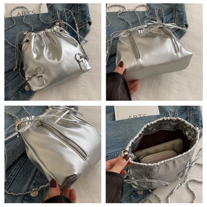 Detailed views of silver drawstring bucket bag featuring chain straps and side zipper accents