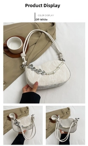 Detail of cream shoulder bag with pearl strap, heart charms and woven handle