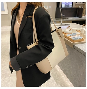 Detail of minimalist two-tone PU leather tote bag with adjustable shoulder straps