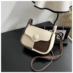 Close-up of beige and coffee patchwork leather mini square bag with a thin shoulder strap
