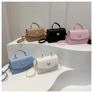 Quilted mini square bags with butterfly clasps shown in five pastel and neutral colors