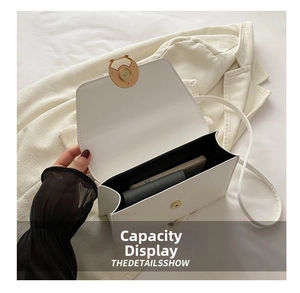 Internal view of a white leather crossbody bag showing space for phone and long wallet