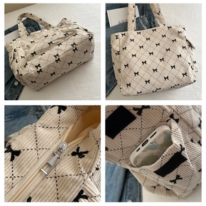 Detail view of corduroy tote bag with bow embroidery and quilted rhombus pattern texture