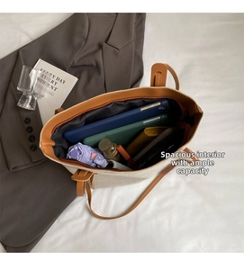 Interior view showing the large capacity and organization of the tote bag with daily items