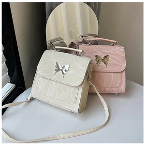 Detail of cream and pink pleated leather handbags with silver butterfly metal buckles