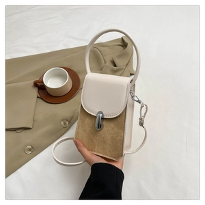 Detailed shot of beige leather stitching and silver twist lock on a vintage crossbody bag