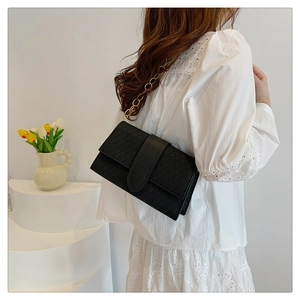 Chic black flap handbag with geometric triangle texture and premium gold chain strap