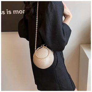 Detail of glitter ball evening bag with crystal handle and golden chain strap