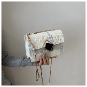 Detail of white leather chain bag with colorful rainbow stripe embroidery and black lock