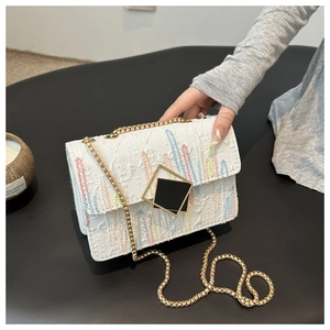 White embroidered chain crossbody bag with colorful vertical stripes and gold hardware