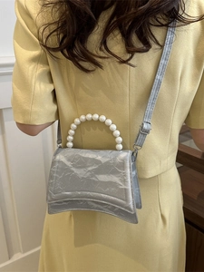 Silver pleated texture handbag with large pearl handle and adjustable shoulder strap