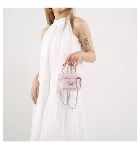 Pink quilted crossbody bag with silver butterfly clasp and metal chain strap detail
