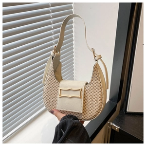 Detail of khaki woven crescent bag with cream PU leather trim and golden metal buckle
