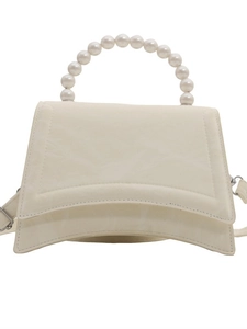 Fashionable off-white hourglass handbag with unique pearl bead handle and shoulder strap