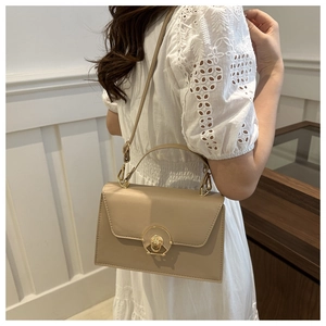 Chic beige crossbody box bag featuring elegant gold round twist lock and premium leather finish