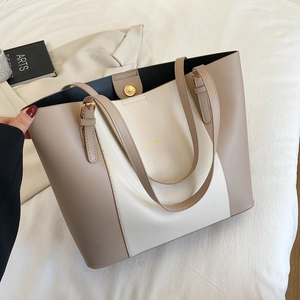 Minimalist bicolor PU leather tote bag with gold logo and adjustable shoulder strap