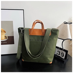 Detail of army green canvas tote with brown leather trim and HT FASHION lettering