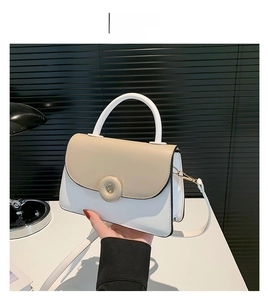 Vue détaillée du petit sac à main bicolore kaki et blanc avec fermoir rond magnétique