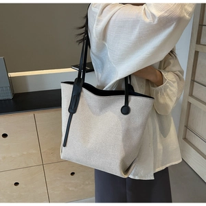 Detailed texture of waterproof nylon tote bag with black leather straps and large capacity