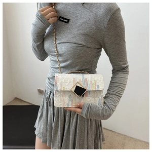 Detail of white leather crossbody bag with FF logo embossing and colorful embroidery
