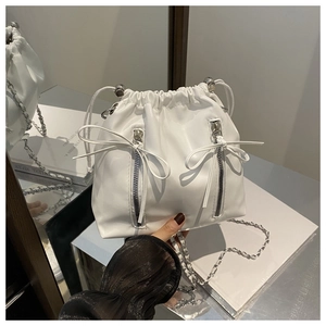 Detail of white PU leather drawstring cloud backpack with silver chain and bow