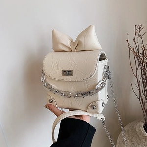 Mini cream crossbody bag with oversized bow, textured finish and silver chain handle