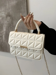 Creamy beige crossbody bag with quilted triangle stitching and golden chain strap