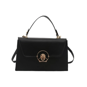 Minimalist black matte leather trapezoid handbag with gold round lock and shoulder strap