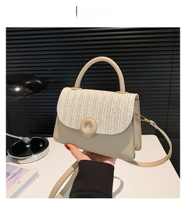 Detail of khaki leather bag with white wave straw weaving and a round metal buckle