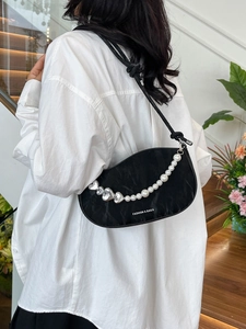 Black saddle shoulder bag with pearl heart chain and Fashion & Bags text logo
