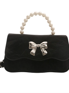 Elegant black faux suede handbag featuring a pearl handle and silver bow buckle closure