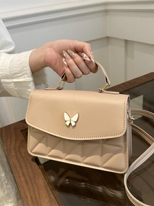 Chic beige quilted crossbody bag with white butterfly metal buckle and top handle