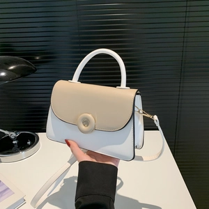 Chic two-tone crossbody bag with round metal buckle and elegant top handle for women
