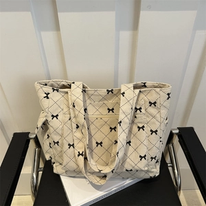 Corduroy quilted tote bag with black bow embroidery and spacious shoulder design