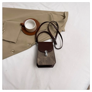 Top view of a retro structured mini handbag with silver oval buckle and a long strap