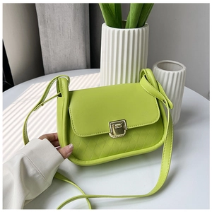 Detail view of lime green crossbody bag with diamond quilted texture and gold clasp