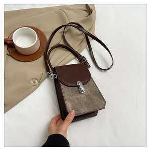 Close-up of the stylish brown and khaki patchwork mini handbag with silver oval clasp