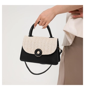 Close-up of the vintage contrast small square bag with woven straw flap and leather body
