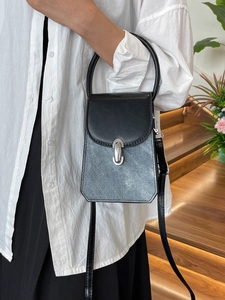 French minimalist mini handbag in black leather and blue denim patchwork for women