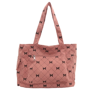 Pink corduroy tote bag with black bow print and quilted pattern in a full front view