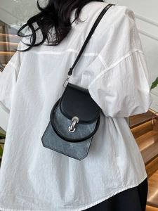 Minimalist small crossbody bag with contrast denim stitching and geometric silhouette