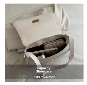 Top-down view of a cream leather crossbody bag interior showing spacious storage capacity