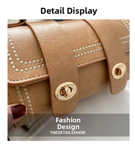 Detail view of lychee texture faux leather bag with floral rivets and gold metal locks