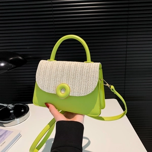 Modern neon green and beige woven crossbody bag held by a model in a urban setting