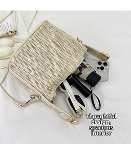 Macro view of straw woven crossbody bag showing spacious interior with daily essentials